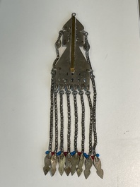 Two silver bracelets, two pendants with carnelian stones, a silver back ornament and a silver capstone, Turkmenistan, 19/20th C.