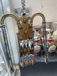 Two silver bracelets, two pendants with carnelian stones, a silver back ornament and a silver capstone, Turkmenistan, 19/20th C.