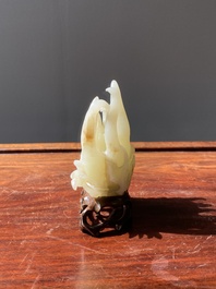 A fine Chinese white jade Buddha's hand on wooden stand, Qing
