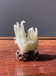 A fine Chinese white jade Buddha's hand on wooden stand, Qing