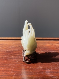 A fine Chinese white jade Buddha's hand on wooden stand, Qing