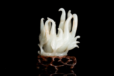 A fine Chinese white jade Buddha's hand on wooden stand, Qing