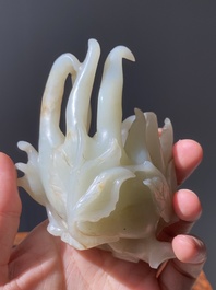 A fine Chinese white jade Buddha's hand on wooden stand, Qing