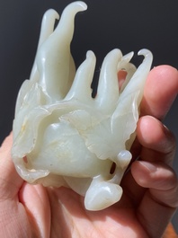 A fine Chinese white jade Buddha's hand on wooden stand, Qing