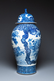 A massive Japanese blue and white Arita vase and cover with an eagle, a shishi and cub, 19th C.