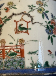 A pair of Chinese powder blue-ground famille verte vessels with a bird in a garden, Kangxi