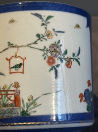 A pair of Chinese powder blue-ground famille verte vessels with a bird in a garden, Kangxi