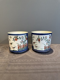 A pair of Chinese powder blue-ground famille verte vessels with a bird in a garden, Kangxi