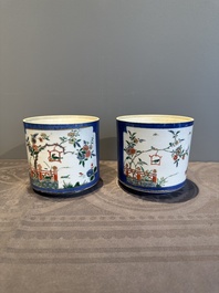 A pair of Chinese powder blue-ground famille verte vessels with a bird in a garden, Kangxi