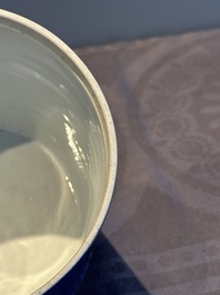 A pair of Chinese powder blue-ground famille verte vessels with a bird in a garden, Kangxi