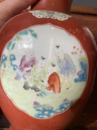 A pair of Chinese famille rose coral-red-ground vases with playing boys, 18/19th C.