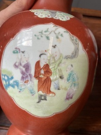 A pair of Chinese famille rose coral-red-ground vases with playing boys, 18/19th C.
