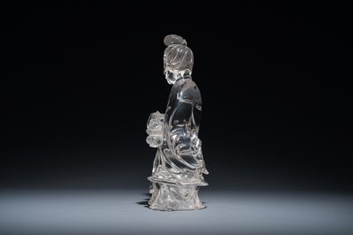 A Chinese rock crystal sculpture of Lan Caihe on wooden stand, 19th C.