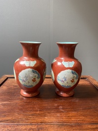 A pair of Chinese famille rose coral-red-ground vases with playing boys, 18/19th C.