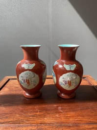 A pair of Chinese famille rose coral-red-ground vases with playing boys, 18/19th C.