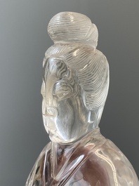 A Chinese rock crystal sculpture of Lan Caihe on wooden stand, 19th C.
