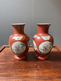 A pair of Chinese famille rose coral-red-ground vases with playing boys, 18/19th C.