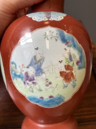 A pair of Chinese famille rose coral-red-ground vases with playing boys, 18/19th C.