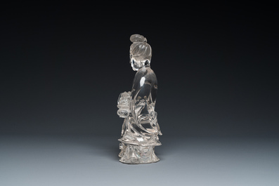 A Chinese rock crystal sculpture of Lan Caihe on wooden stand, 19th C.