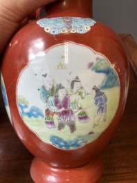 A pair of Chinese famille rose coral-red-ground vases with playing boys, 18/19th C.