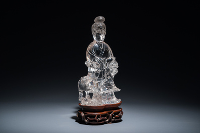 A Chinese rock crystal sculpture of Lan Caihe on wooden stand, 19th C.