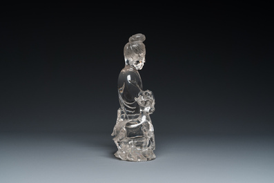 A Chinese rock crystal sculpture of Lan Caihe on wooden stand, 19th C.