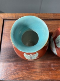 A pair of Chinese famille rose coral-red-ground vases with playing boys, 18/19th C.