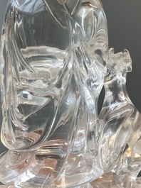 A Chinese rock crystal sculpture of Lan Caihe on wooden stand, 19th C.