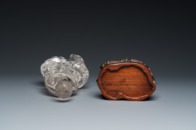 A Chinese rock crystal sculpture of Lan Caihe on wooden stand, 19th C.