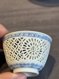 A Chinese blue and white reticulated double-walled cup and saucer, lingzhi mark, Kangxi