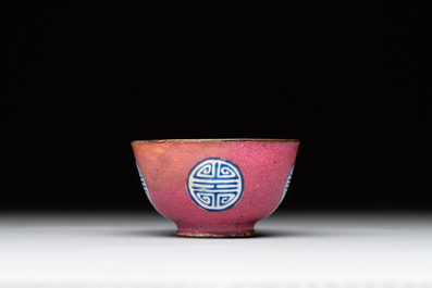 A rare Canton enamel ruby-ground 'Bats and Shou' cup on stand, Qianlong mark and of the period