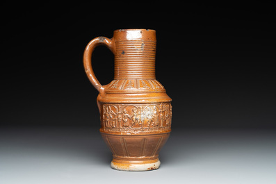 A Raeren stoneware 'peasant dance' jug, late 16th C.