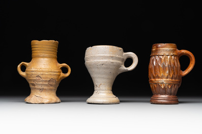 14 German stoneware jugs, mugs and vessels, 14/16th C.