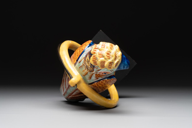A polychrome Dutch Delft parrot on a later metal stand, 18/19th C.