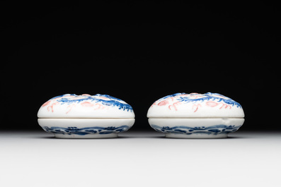 A pair of Chinese blue and white and a pair of blue, white and copper-red seal paste boxes, Kangxi and Qianlong mark, 19th C.