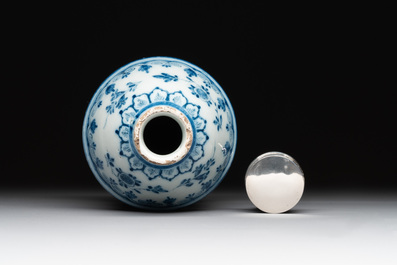 A Dutch Delft blue and white tea caddy with a pipe smoker, 18th C.