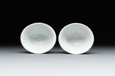 A pair of Chinese Dehua blanc de Chine relief-decorated famille rose 'prunus' cups, 19th C.
