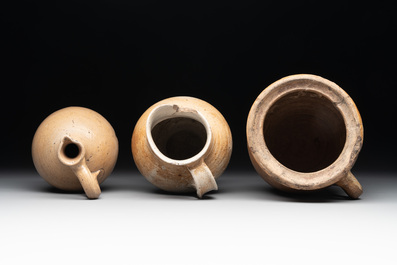 18 German stoneware jugs, mugs and vessels, 15th C. and later
