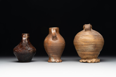 A collection of 13 German stoneware jugs, 15th C. and later