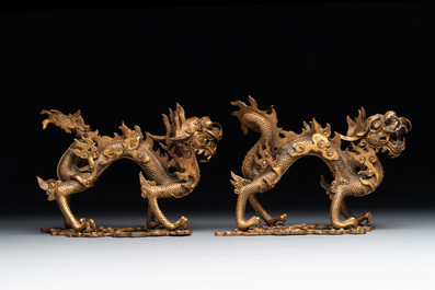 A pair of Chinese gilt bronze dragons among flames and clouds, 19/20th C.