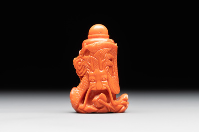 A Chinese carved red coral 'dragon' snuff bottle on wooden stand, 19/20th C.