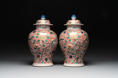 A pair of Chinese famille verte 'phoenix' vases and covers, 19th C.