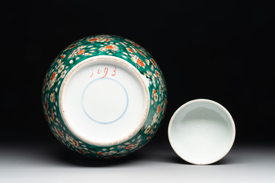 A pair of Chinese famille verte green-ground 'prunus' jars and covers, 19th C.