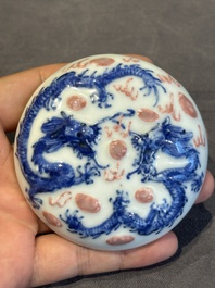 A pair of Chinese blue and white and a pair of blue, white and copper-red seal paste boxes, Kangxi and Qianlong mark, 19th C.