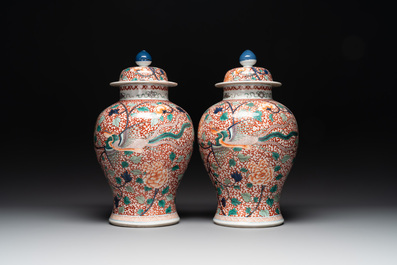 A pair of Chinese famille verte 'phoenix' vases and covers, 19th C.
