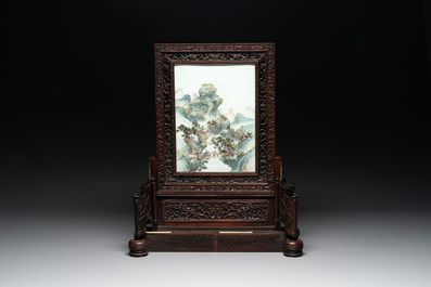 A large Chinese carved wooden table screen with a fine famille rose 'landscape' plaque, 19th C.
