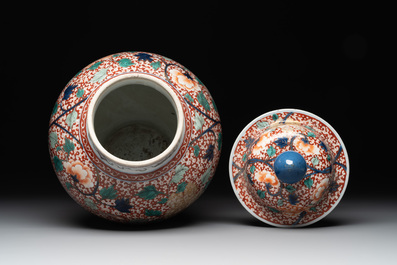 A pair of Chinese famille verte 'phoenix' vases and covers, 19th C.