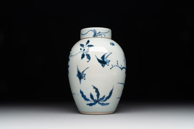 A Chinese blue and white jar and cover with birds among flowering branches, Transitional period