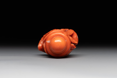 A Chinese carved red coral 'dragon' snuff bottle on wooden stand, 19/20th C.