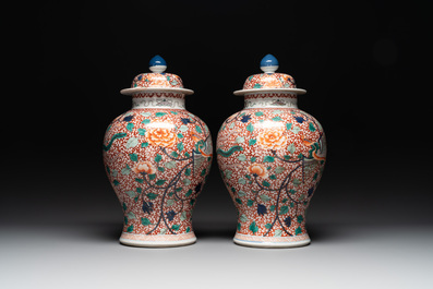 A pair of Chinese famille verte 'phoenix' vases and covers, 19th C.